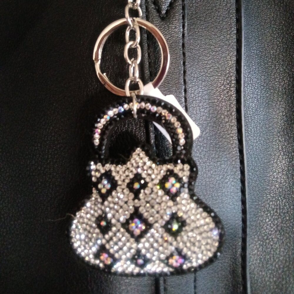 A crystal embellished bag charm/key chain in the shape of a purse